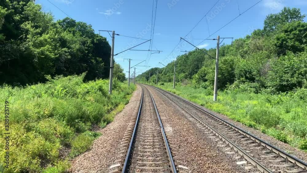 Railway with traffic, with a natural background, green trees, electric poles. Railway with traffic, with a natural background, green trees, electric poles.