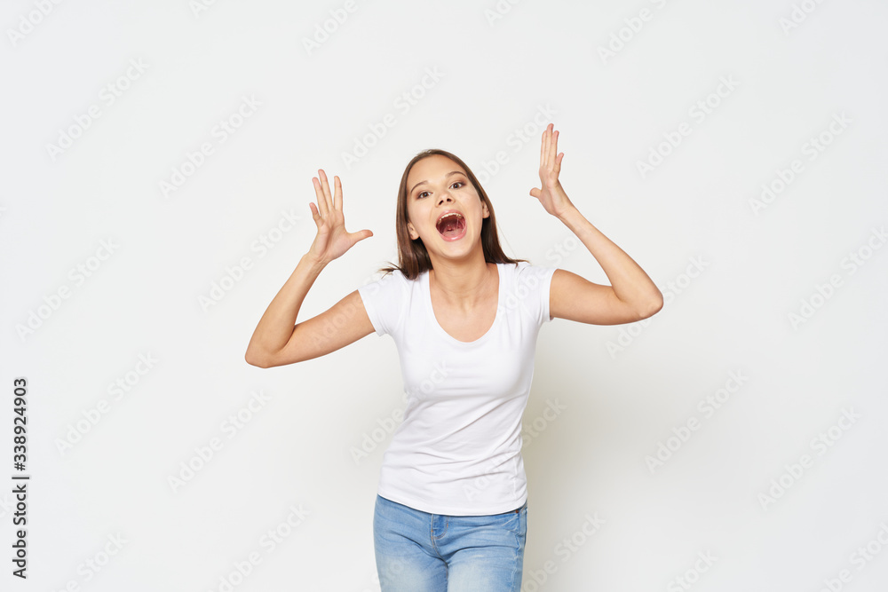 Cheerful emotional girl white t-shirt studio gesture with hands Cheerful emotional girl white t-shirt studio gesture with hands