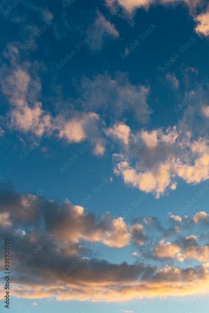 evening sky with clouds beautifully illuminated by the setting sun as a natural background