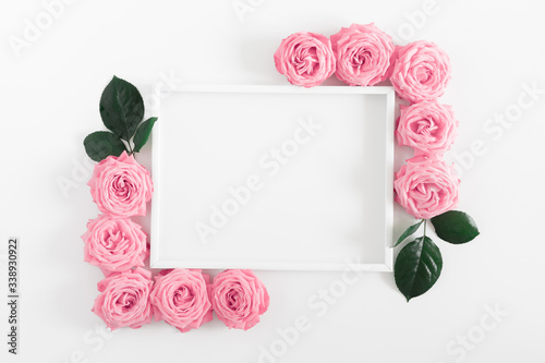 Fototapeta Naklejka Na Ścianę i Meble -  Beautiful flowers composition. Frame made of pink flowers on white background. Pink rose pattern. Valentines Day, Birthday, Happy Women's Day, Mother's day. Flat lay, top view, copy space