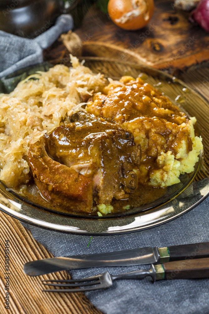 Fried ribs in sauerkraut served with boiled potatoes. Fried ribs in sauerkraut served with boiled potatoes.