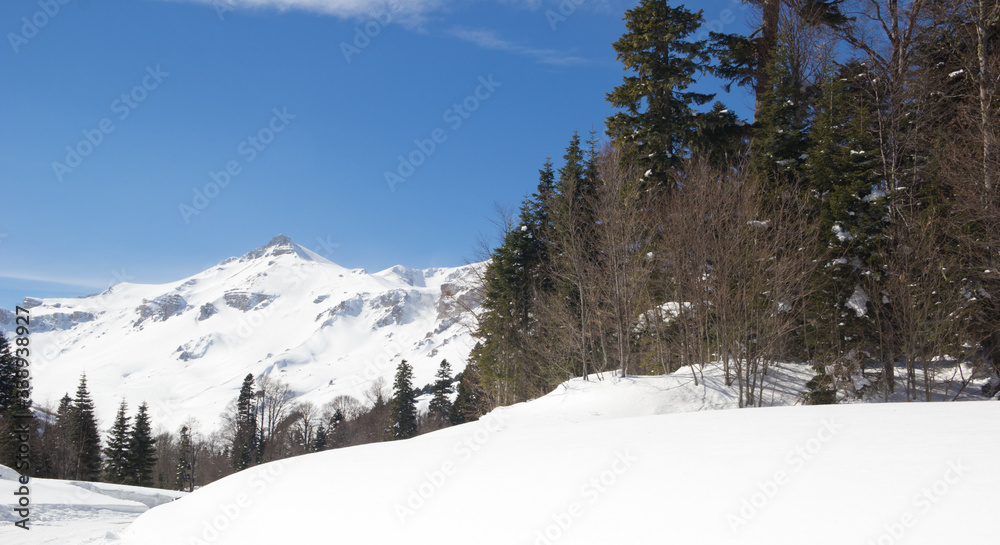 Beautiful mountains covered with snow. Sunny day and blue sky on a frosty day