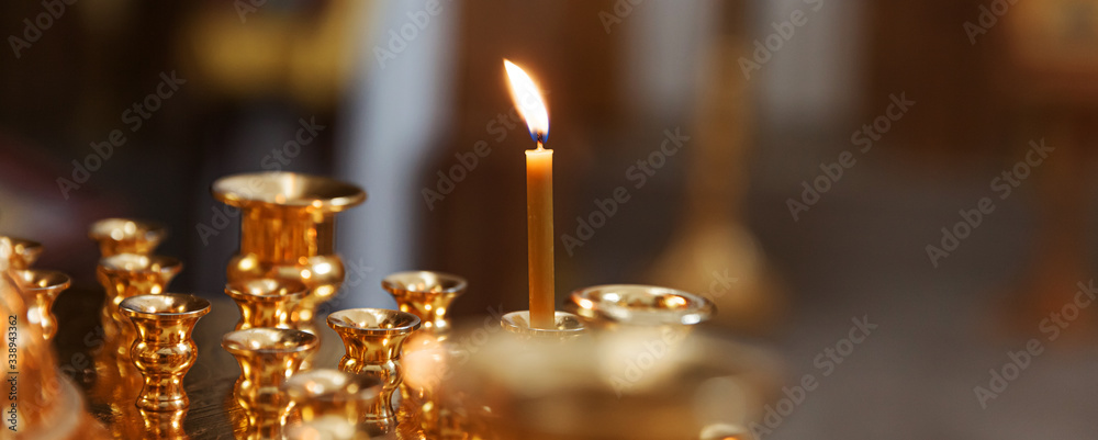 Orthodox Church. Christianity. Festive interior decoration with burning candles and icon in traditional Orthodox Church on Easter Eve or Christmas. Religion faith pray symbol.