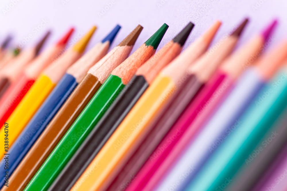 color pencils on purple background, close-up color pencils on purple background, close-up