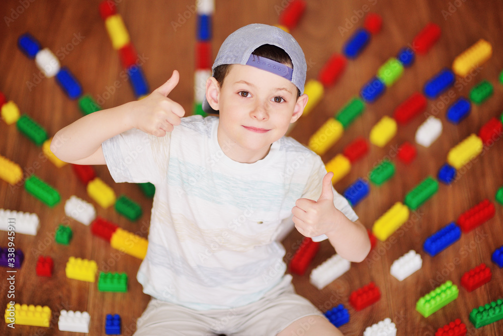 a child a small boy a preschooler in a cap worn backwards sitting on ...