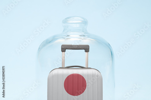 Luggage in isolation under glass cover covid-19 Japan tourism abstract.