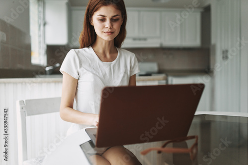 Woman thinking in front of a laptop interior communication rest