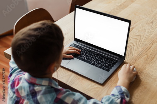 boy child sitting at a laptop, learning remotely, online classes, mock up