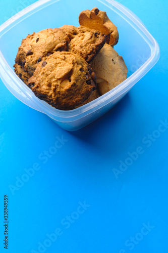 Homemade chocolate cookies pile on a blue background