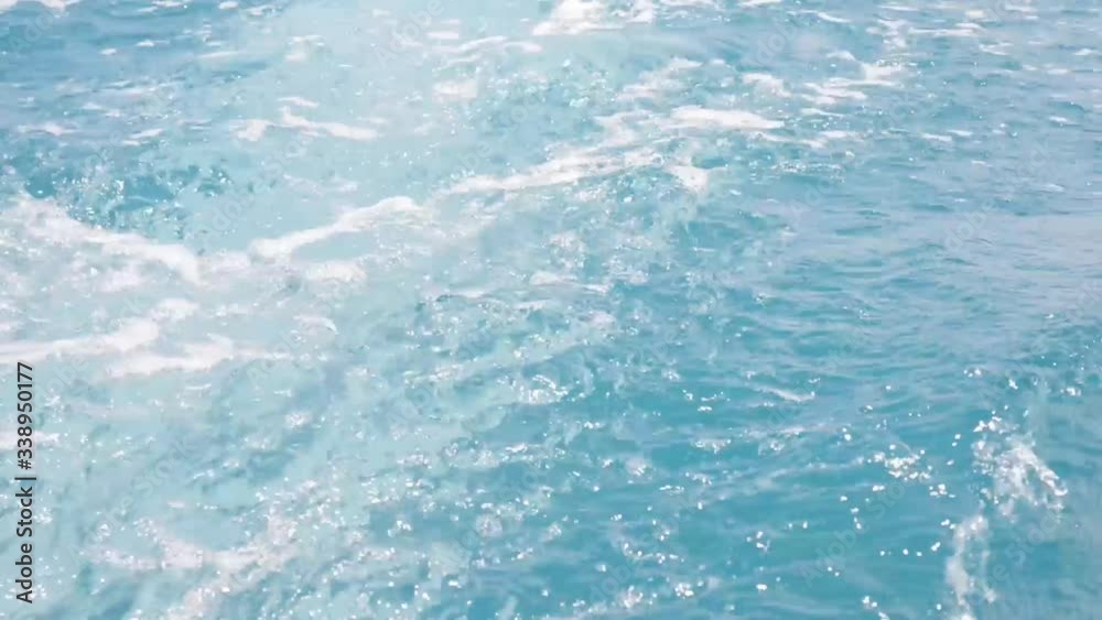 Blue water of ocean with sunny reflections. Blue clear water with the waves is close up. Relax travel concept. Background is horizontal frame. Space for text Blue water of ocean with sunny reflections. Blue clear water with the waves is close up. Relax travel concept. Background is horizontal frame. Space for text