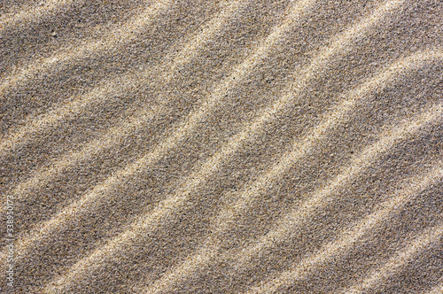 Lines pattern on sand of dunes on beach.