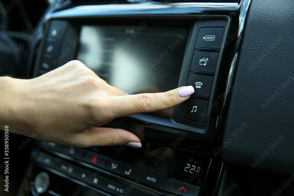 driver's hand push the button of telephone on the dashboard in the car