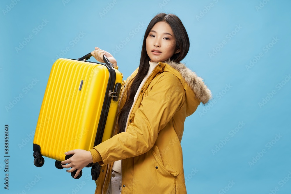 Woman tourist travel suitcase on vacation blue airport background