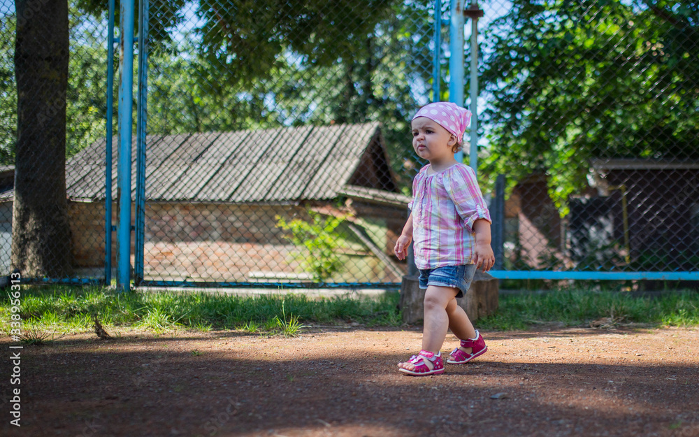 Little girl runs on a sports ground Little girl runs on a sports ground