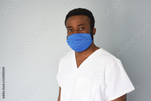 Doctor in mask. Black man african american doctor portrait wearing safety mask at work. Medical staff. Coronavirus. © Aksinia
