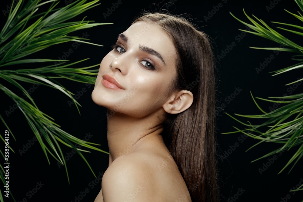 Beautiful woman green leaves charm Exotic naked shoulders Beautiful woman green leaves charm Exotic naked shoulders