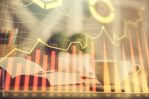 Multi exposure of forex graph drawing and desktop with coffee and items on table background. Concept of financial market trading © peshkova