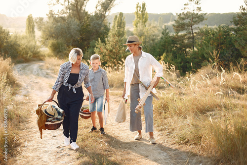 Two mothers with son. Family in a spring field.