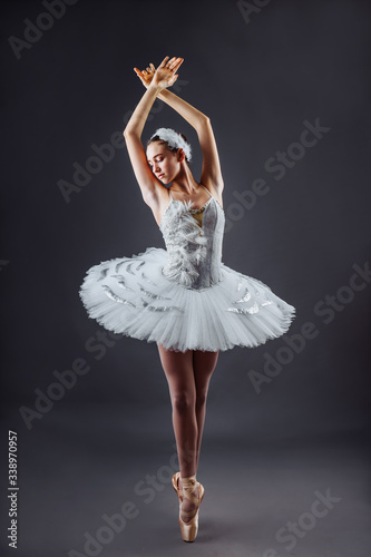 Fototapeta Ballerina dancing in white dress