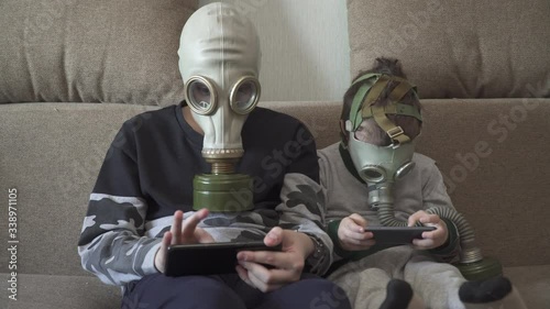Children in gas masks from viruses play with smartphones