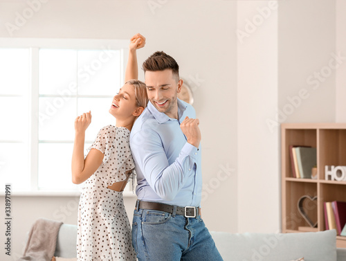 Happy dancing young couple ...