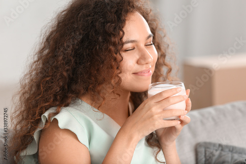 Young woman drinking tasty ...