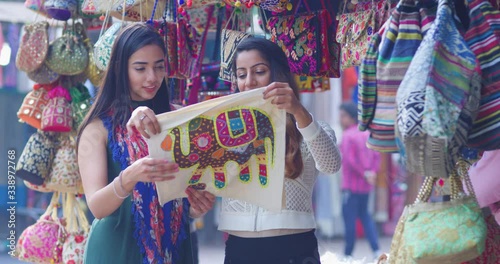 4K Happy young Indian women shopping in the market. Slow motion.