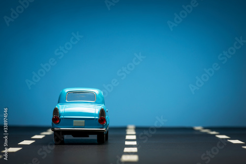 Fototapeta Naklejka Na Ścianę i Meble -  Rear view of a Blue toy car on a blue background.