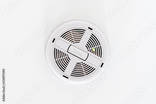 Ceiling mounted white colored mains powered smoke detector