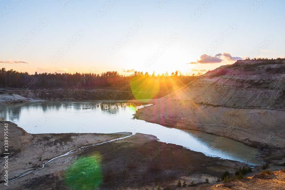 Sunset in the background of an abandoned quarry.