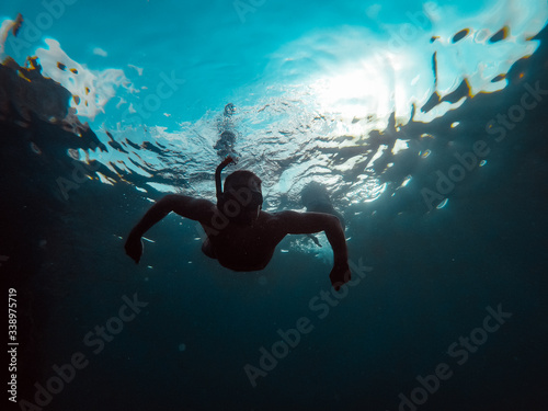 Underwater photo of man snorkeling in a sea