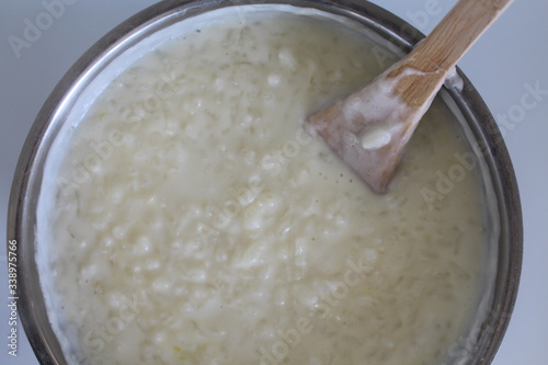 Cooking of rice porridge on oven, the first stage of preparation of national Finnish dish from rye flour and rice - Karelian pies photo