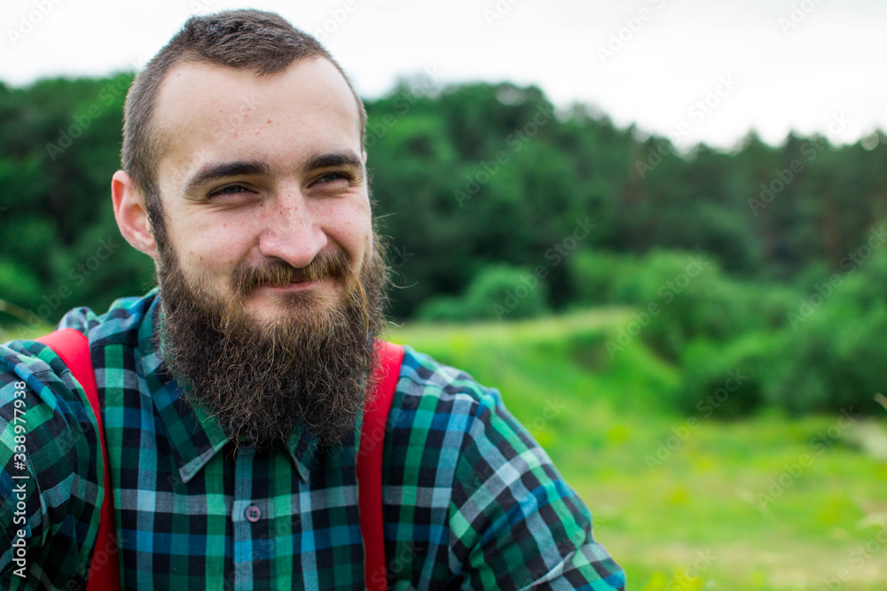 Handsome man hipster with beard on serious face in cloth shirt and suspenders sunny outdoor on mountain top against cloudy sky on natural. Tourism concept. Wonderful landscape. Handsome man hipster with beard on serious face in cloth shirt and suspenders sunny outdoor on mountain top against cloudy sky on natural. Tourism concept. Wonderful landscape.