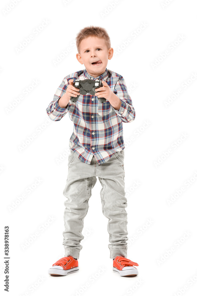 Cute little boy playing video games on white background Cute little boy playing video games on white background