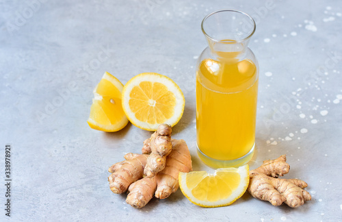 Ginger Ale - Homemade lemon and ginger organic probiotic drink or Kombucha. Ginger-lemon drink in a bottle, ingredients of ginger cocktail or tea: ginger root, lemon. copy space. selective focus