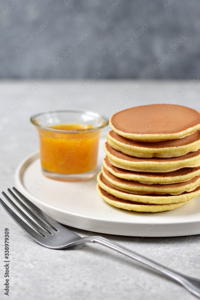 pancakes with lemon jam on a white craft plate. family Breakfast dish, food for children in the morning.  pancake recipe. food delivery gluten free pancakes