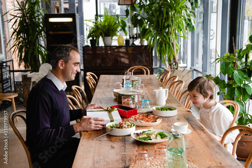 Family of two enjoying time together in a cafe photo