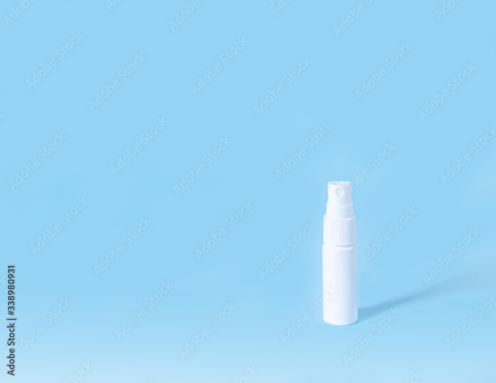 White bottle with an antiseptic for hands in the form of a spray on a blue background. Banner White bottle with an antiseptic for hands in the form of a spray on a blue background. Banner