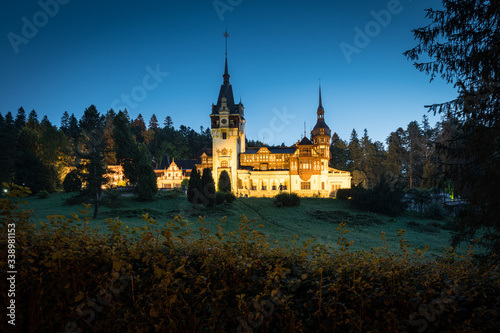 Peles Castle, famous residence of King Charles I in Sinaia, Romania. Summer landscape at dawn of royal palace and park.