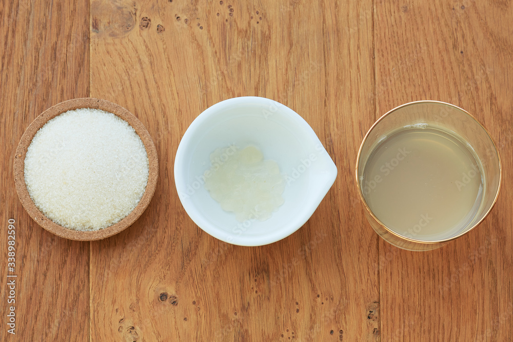 A flatlay overhead shot of the ingredients in line for water kefir drink, including dried dates and organic raw cane sugar. A flatlay overhead shot of the ingredients in line for water kefir drink, including dried dates and organic raw cane sugar.