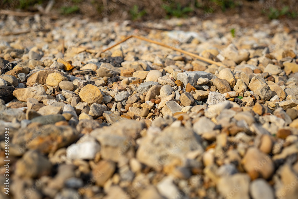 Close up of colorful stones and pebbles on a beach with shallow depth of field Close up of colorful stones and pebbles on a beach with shallow depth of field