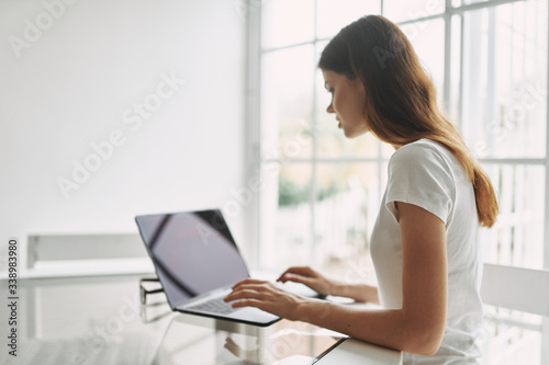 Woman at home in front of laptop communicating interior