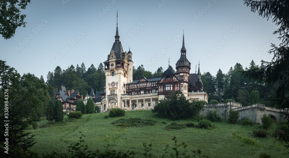 Peles Castle, famous residence of King Charles I in Sinaia, Romania. Summer landscape at dawn of royal palace and park.