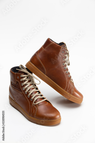 Closeup of Motorcyclist Tan Leather Protective Boots. Against White Background.