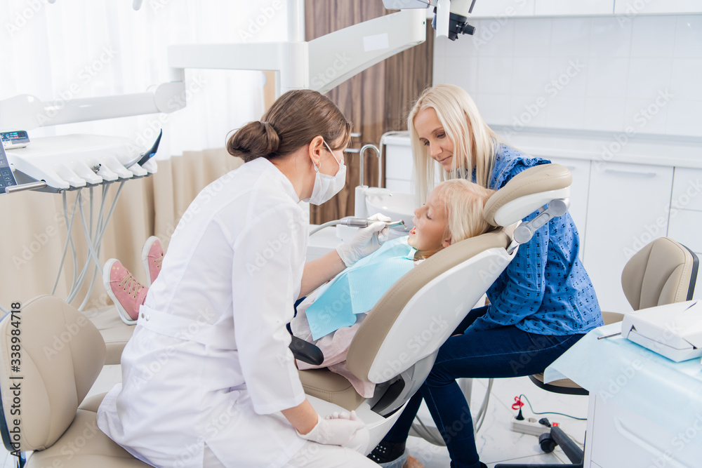 A child having a dental checkup with her mother A child having a dental checkup with her mother
