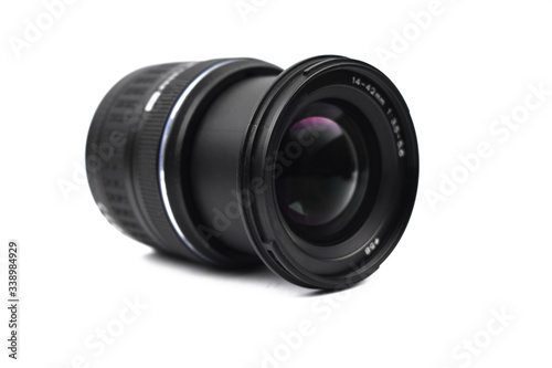 Front view of a camera lens of black color placed on an isolated empty white background