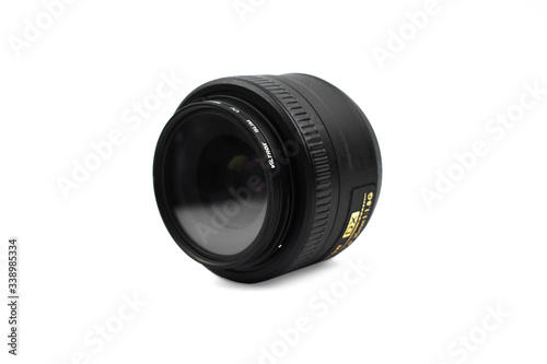 Single black color camera lens of a digital camera placed over a white background