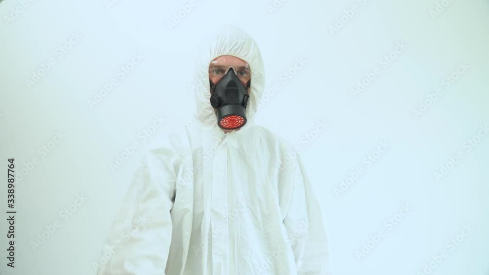 Man in protective coverall and respirator shows the fuck you middle finger. Fuck coronavirus Man in protective coverall and respirator shows the fuck you middle finger. Fuck coronavirus
