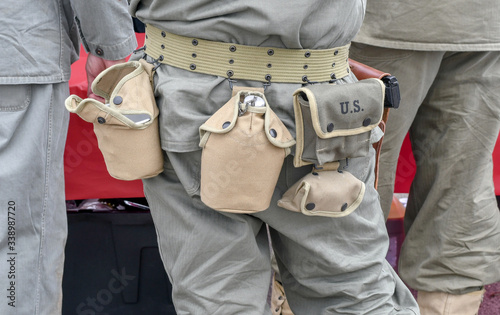 Soldier sports a belt with important tools hanging from it for military use in the desert