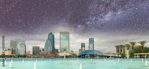 Jacksonville, Florida. Panoramic view of city downtown and brigde on a starry night with milky way, USA
